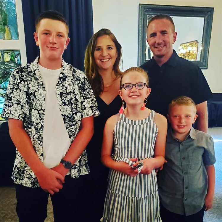 family standing in front of window